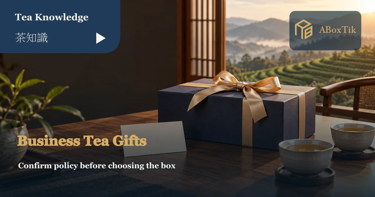 Navy gift box, blank card and tea cups on a meeting table