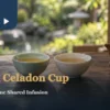 Celadon tea cup beside a white porcelain cup of tea, with a clay pot and dry leaves