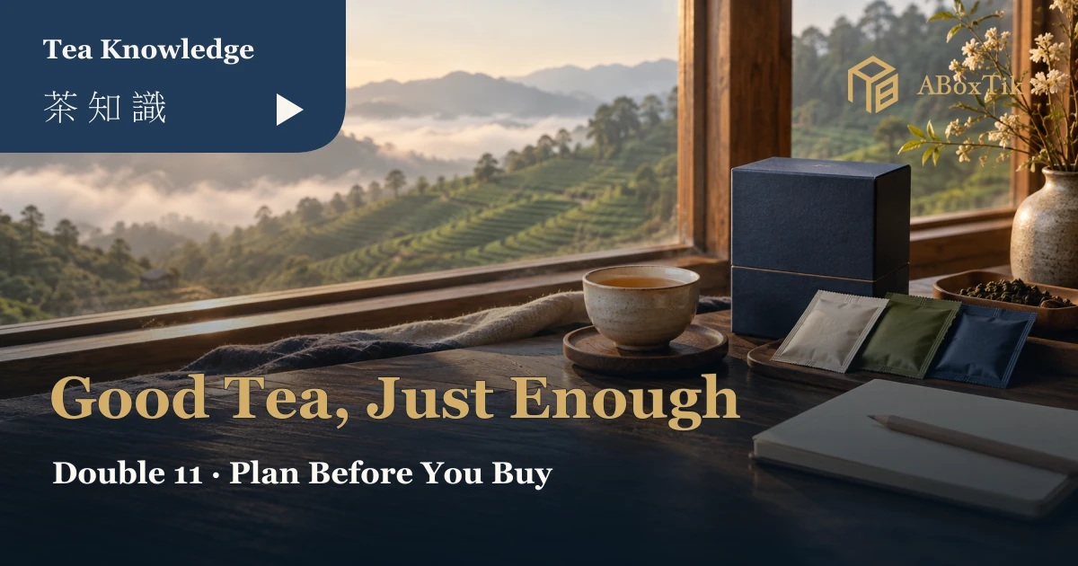 A cup, sealed tea sachets and a blank notebook on a warm window-side tea table for shopping planning
