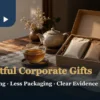 Open kraft gift box with two sealed tea packets, amber tea in a glass cup, ceramic teapot and blank card on a wooden table