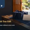 A navy gift box and blank card on a wooden cabinet