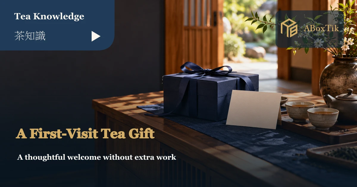 A navy gift box and blank card on a wooden cabinet