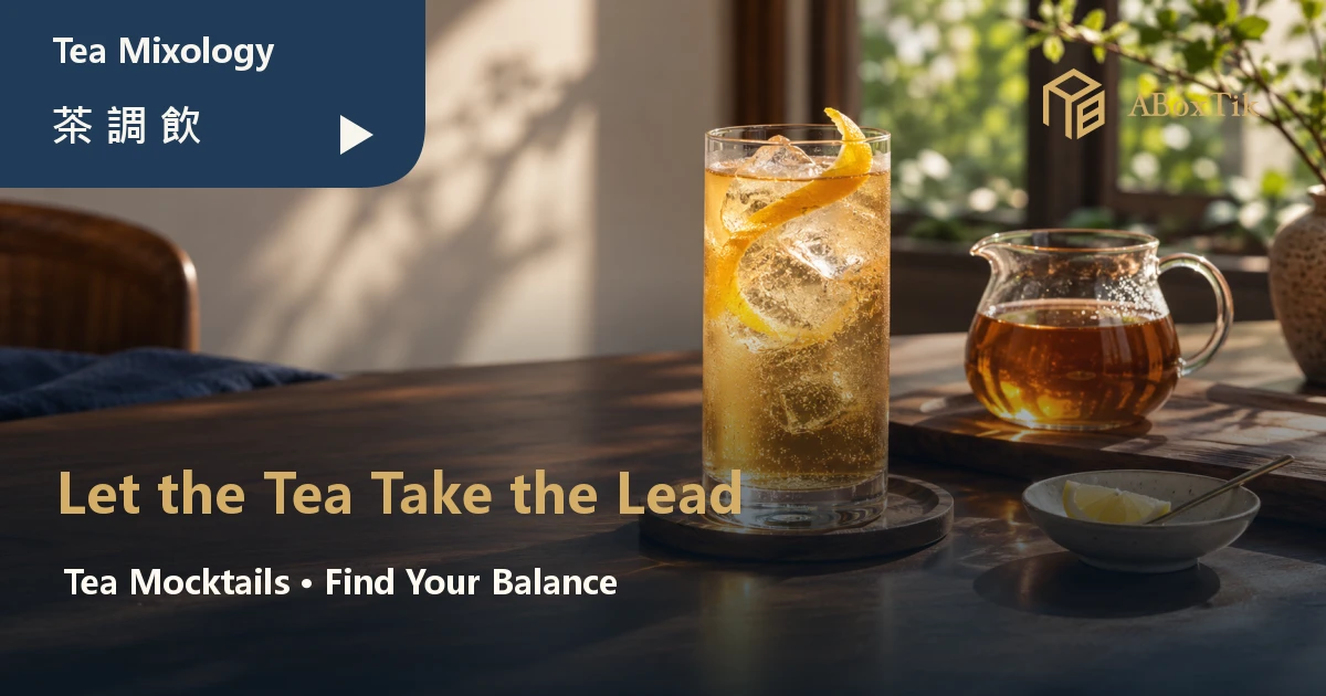 Golden oolong tea mocktail with ice and citrus peel beside plain tea in warm window light