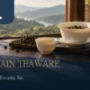 White porcelain gaiwan and cup with Taiwanese oolong in a warm wooden tea setting