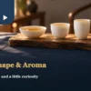 Three white porcelain cups with different openings and depths, filled with amber tea on a wooden tray