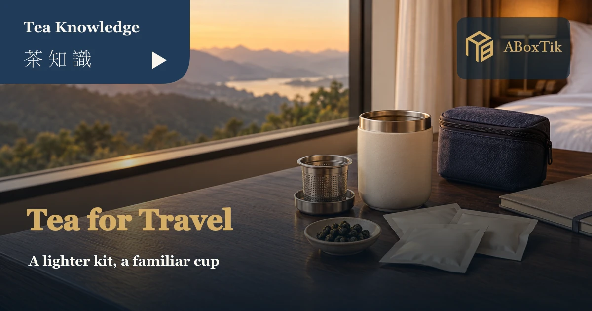 Tea for travel setting with travel mug, infuser and dry tea portions by a window