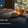 A glass tea pitcher, golden tea and a small dish of leaves