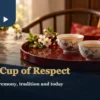 Wedding tea preparation scene with two porcelain cups on a red tray and a red and gold fabric accent